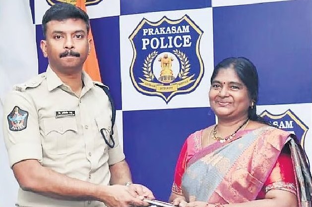 Prakasam Police officer, Andhra Pradesh, handing a recovered mobile phone back to its owner