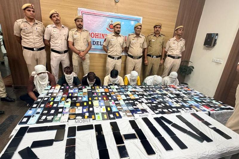 Delhi Police, Rohini, with recovered mobile phones laid out on a table, some arranged to spell ROHINI